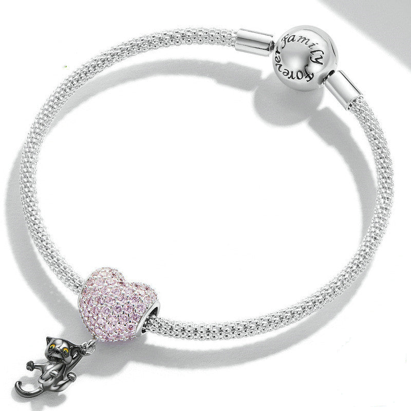 Cat Heart Charm attached to a silver bracelet, showcasing its stylish and whimsical design. A must-have accessory for charm bracelet enthusiasts.