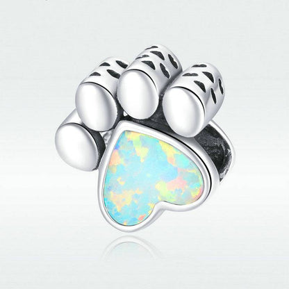 Charming dog paw charm with opal heart detail