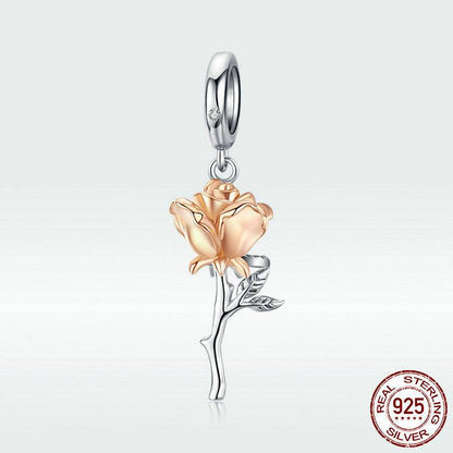 Gold rose charm in sterling silver setting