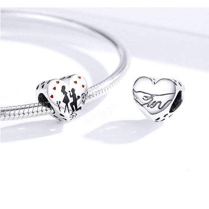 Heart-shaped engagement charm on bracelet