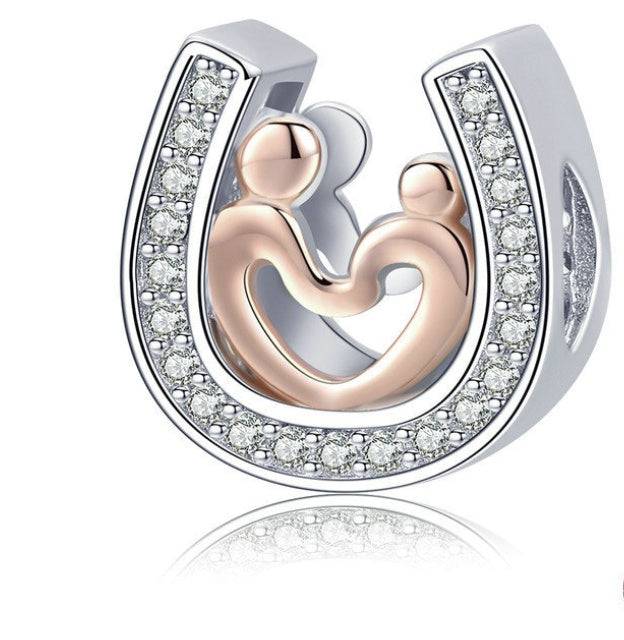 Horseshoe charm with rose gold figures and crystal accents.