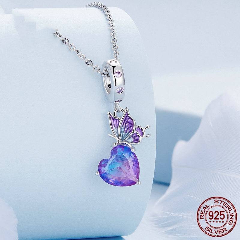 Crystal Butterfly Charm displayed on a silver necklace, showcasing its sparkling purple gemstone and intricate butterfly wing details.