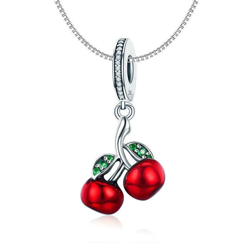 Cherry Charm pendant displayed on a silver necklace, showcasing red cherries and green leaf details. A stylish and elegant accessory for any occasion.