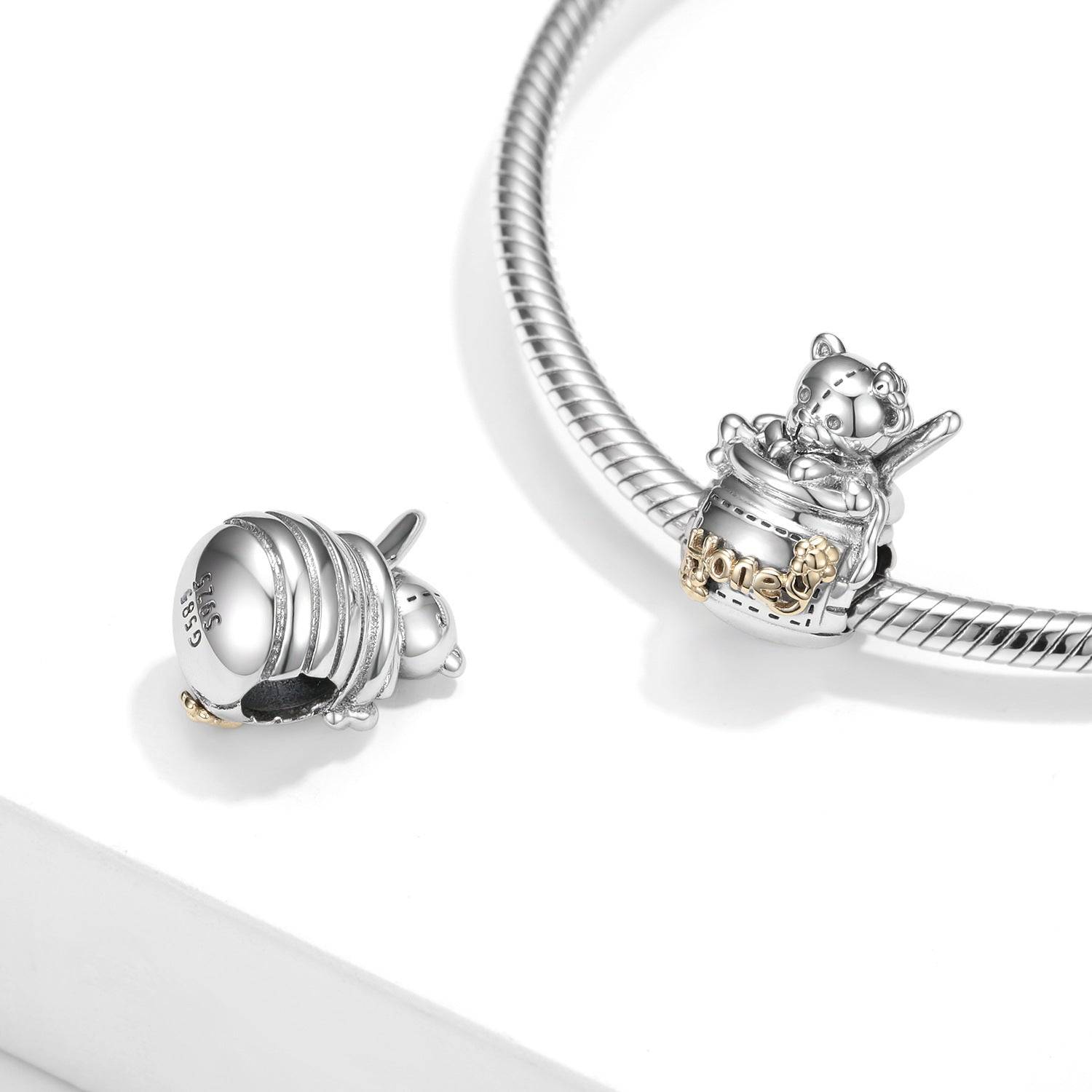 Honey Bear Charm displayed on a silver bracelet, showcasing its intricate design and compatibility with charm bracelets.