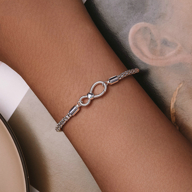 Infinity Knot Silver Bracelet worn on wrist