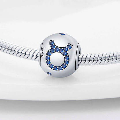 Taurus zodiac charm in sterling silver with blue crystal accents, crafted for durable and stylish personalized jewelry collections.