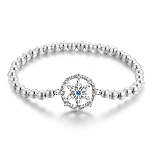 Elegant silver snowflake bracelet with a delicate blue gemstone centerpiece.