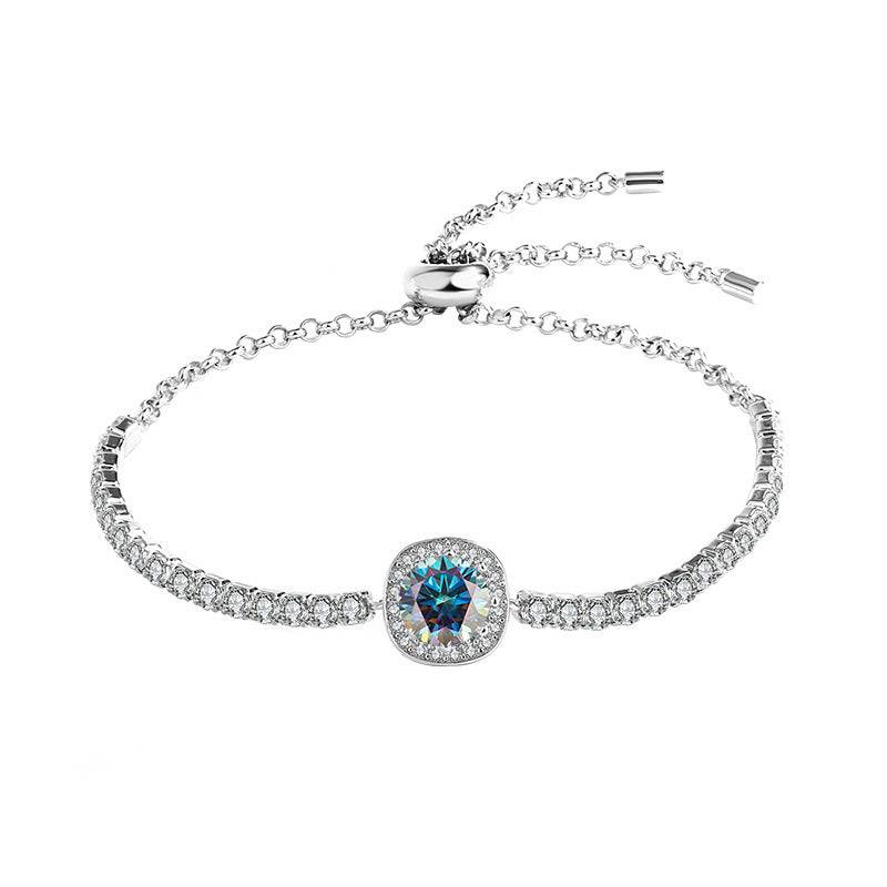 Silver moissanite galaxy bracelet with a blue central stone and sparkling accents, showcasing a celestial theme.