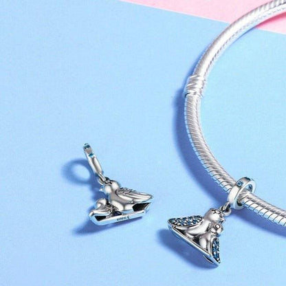 Bird charm on a bracelet with blue crystals