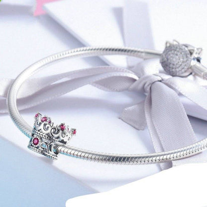 Crown charm on a silver bracelet